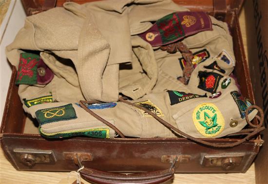 Two Bukta scout shirts with badges, 1950s-60s in a case